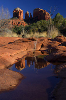 Cathedral Rock and its reflection in a still pool of water at Red Rock Crossing